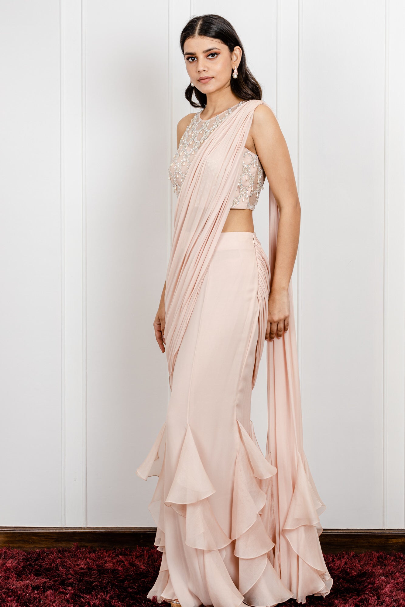 Ruffled Skirt Saree with a Side Drape And a Pearl Dropped Blouse